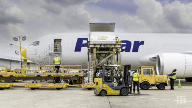 A white Polar air cargo jet gets loaded with a container through a side door.