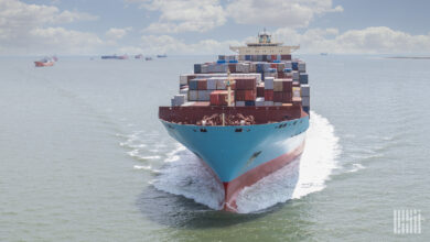 A loaded container ship nearing a port