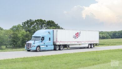 A powder blue Heartland Express tractor pulling a white Heartand Express 53-foot trailer