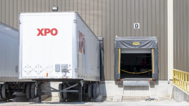 A white XPO LTL trailer loading at a facility
