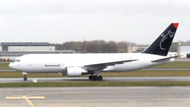 Side view of a white cargo plane on the runway.