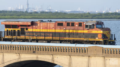 A freight train crosses over a bridge.