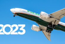A view of a plane flying overhead with a 2023 year imposed in the frame for the year-in-review story.