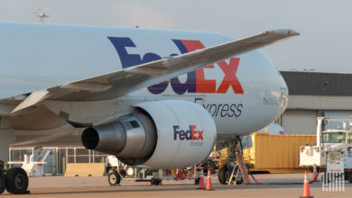Close of a FedEx jet, off the wing, at an airport.