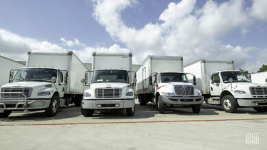 Several straight trucks loading at a facility