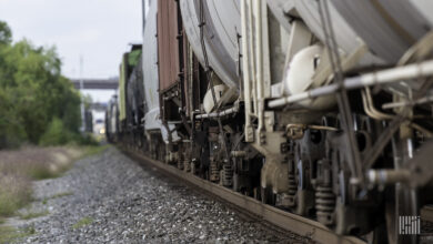 A close up of the wheels of a freight train as it rolls down the track.