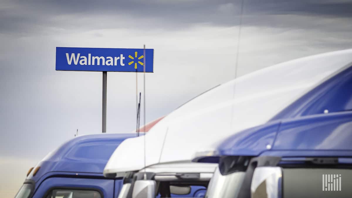 Trucks in front of a Walmart facility. Walmart Canada says a blockchain payment platform had dramatically reduced invoice disputes.